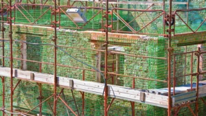 construction site with carbon fiber weave for restoring, repairing and rebuilding of an old building with supporting structure in brick masonry